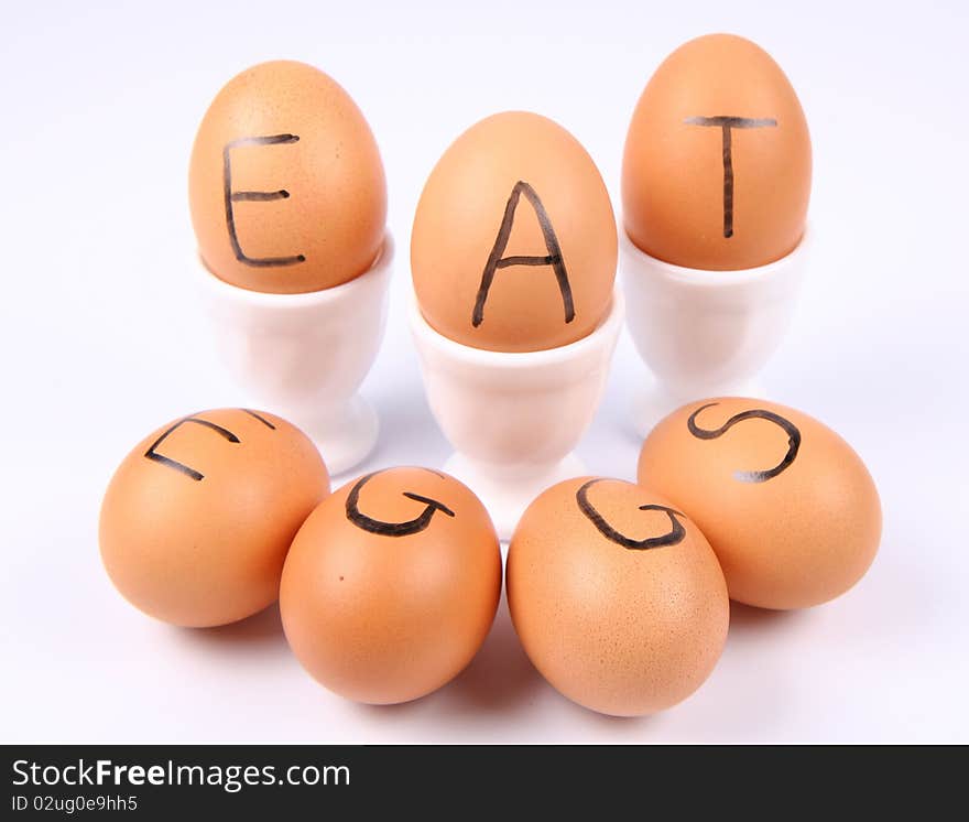 Eggs with an inscription EAT EGGS on white background