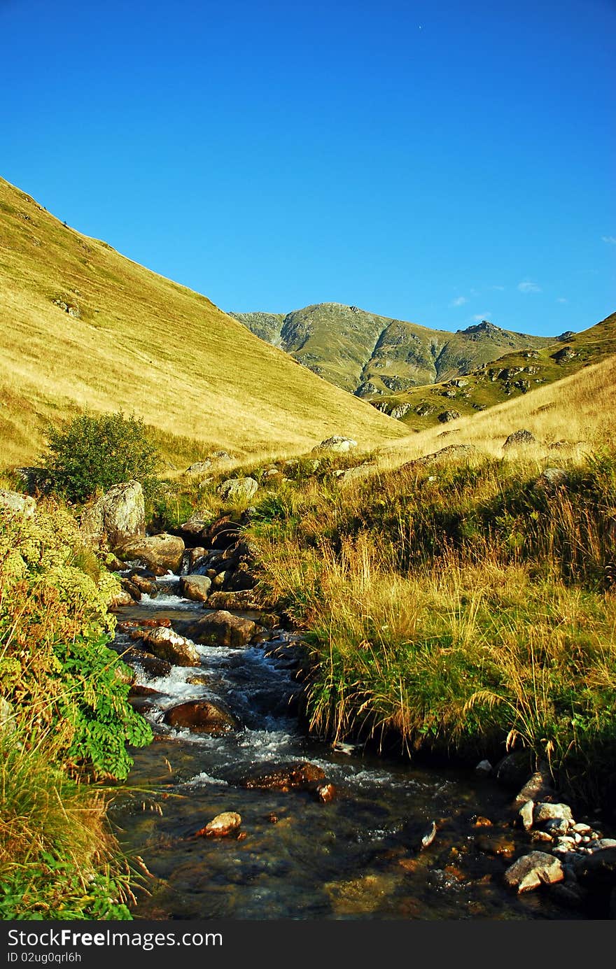 Mountain valley with water stream