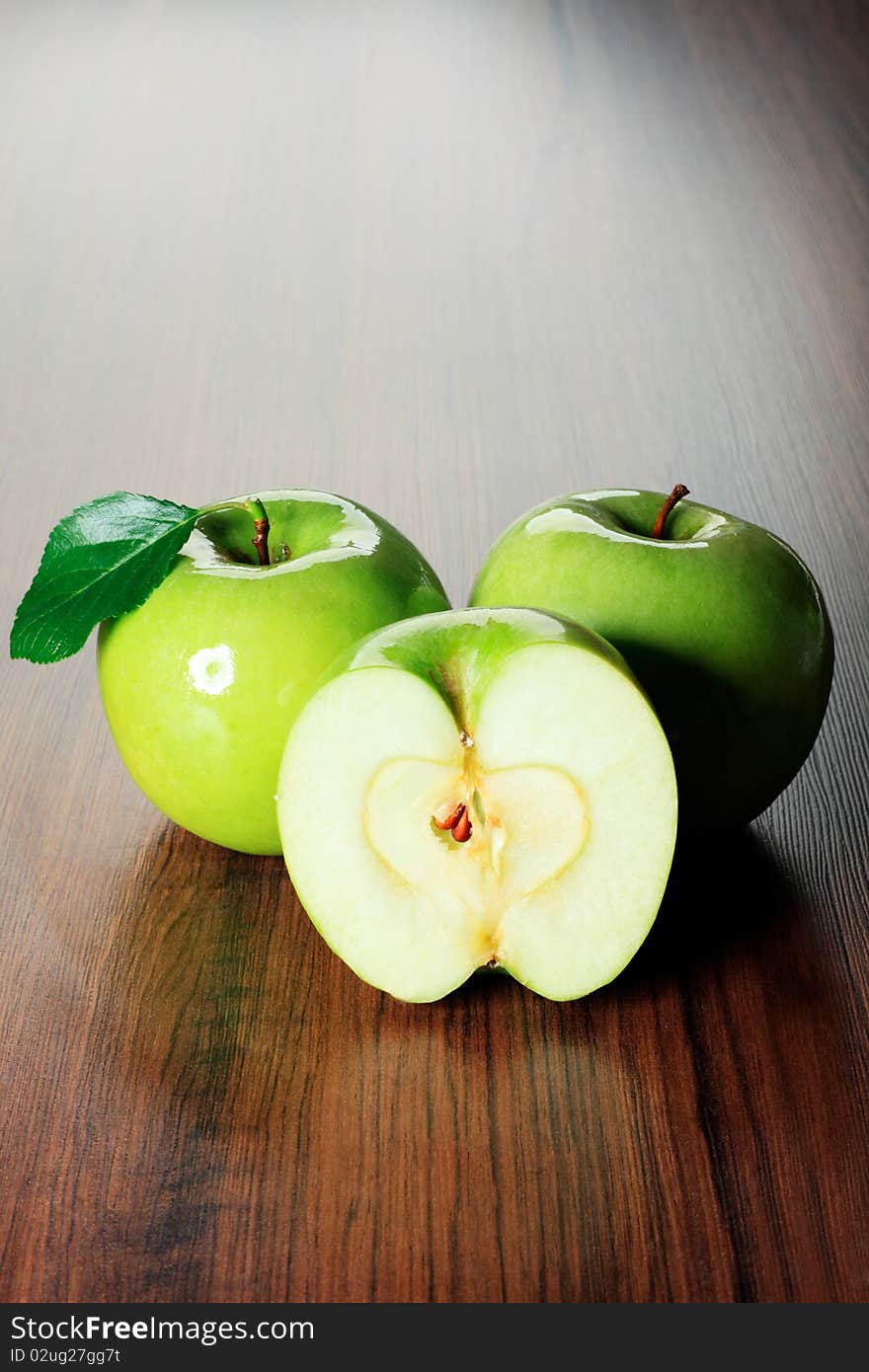 Shot of fresh green apples with green leaf on a table. Shot of fresh green apples with green leaf on a table.