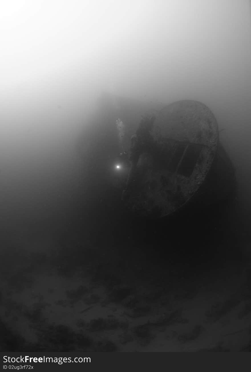 The stern section anti aircraft guns of the world war two shipwreck the SS Thistlegorm, Scuba diver in the background. Red Sea, Egypt. The stern section anti aircraft guns of the world war two shipwreck the SS Thistlegorm, Scuba diver in the background. Red Sea, Egypt.