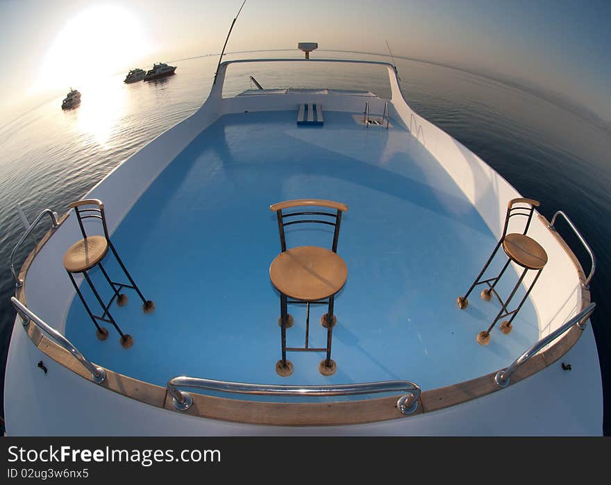 Sun deck of a boat used for sunbathing and relaxing with a a calm sea surrounding. Red Sea, Egypt. Sun deck of a boat used for sunbathing and relaxing with a a calm sea surrounding. Red Sea, Egypt.