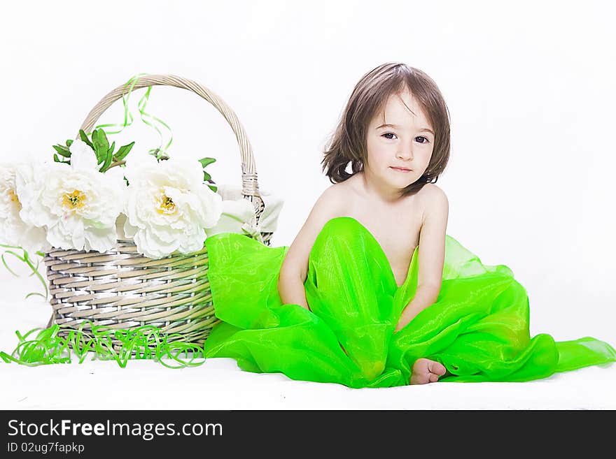 Portrait of a little girl with basket and flowers isolated