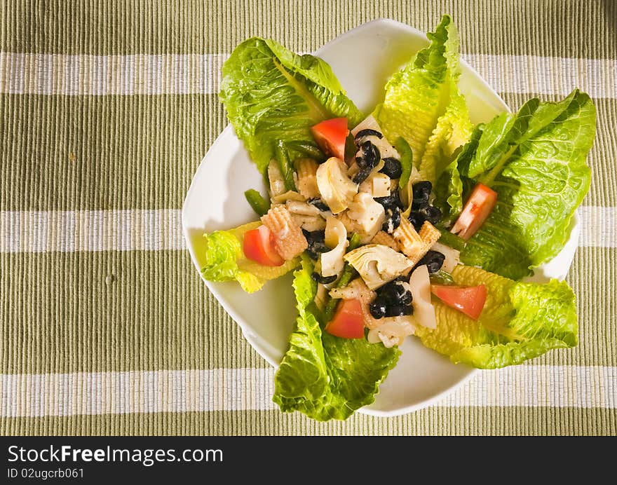 Antipasto salad with lettuce, tomatoes, olives and corn