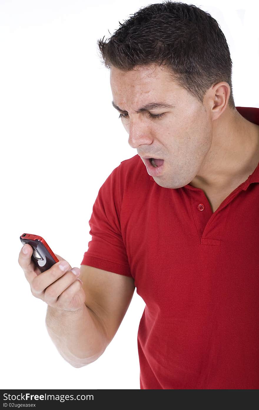 Young man yells into his wireless phone. Young man yells into his wireless phone