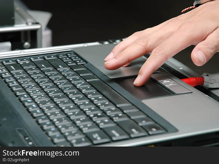 Close up of a hand typing on laptop keyboard. Close up of a hand typing on laptop keyboard