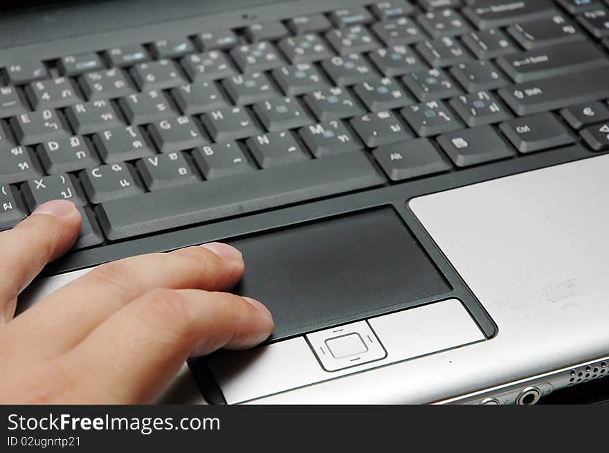 Close up of a hand typing on laptop keyboard. Close up of a hand typing on laptop keyboard