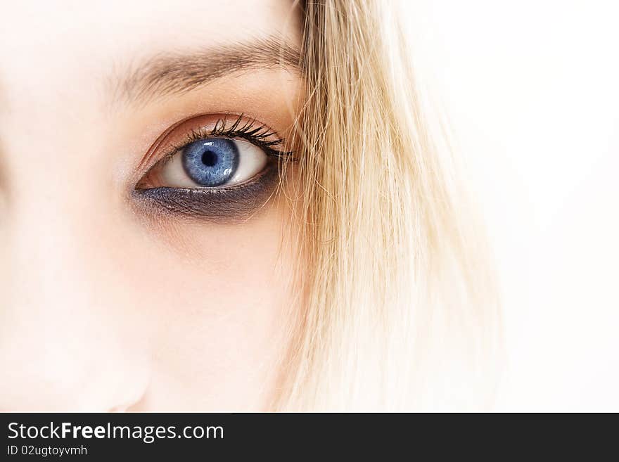 Woman eye, close-up shot, half face