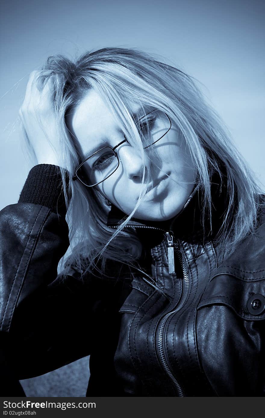 Beautiful young woman posing over sky, cold tone