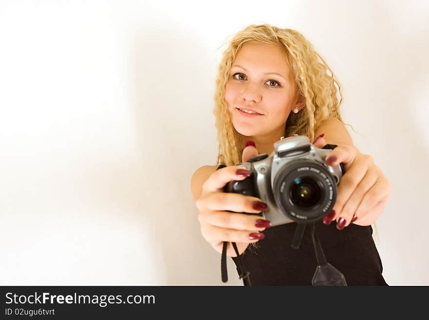 The young beautiful girl with the camera isolated on a white background