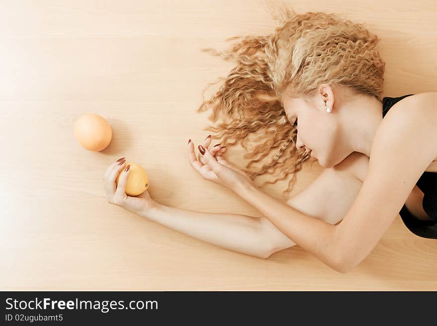 Girl and fruits lies on floor, abstract