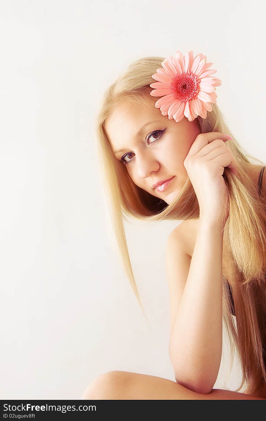 Beautiful young pretty woman with flower in hair