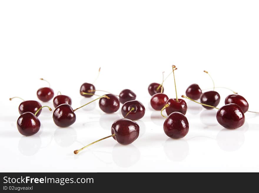 Ripe cherries isolated on white, scattered