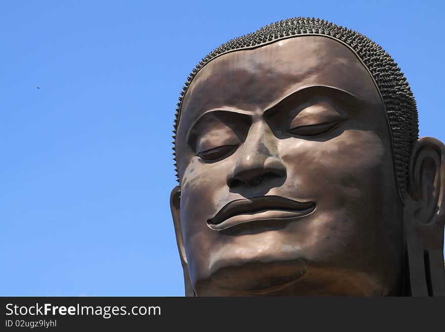 Face of Buddha from the temple of Wat Tummickarat in Ayutthaya Historic Park, Thailand. Ayutthaya is one of world heritage park.