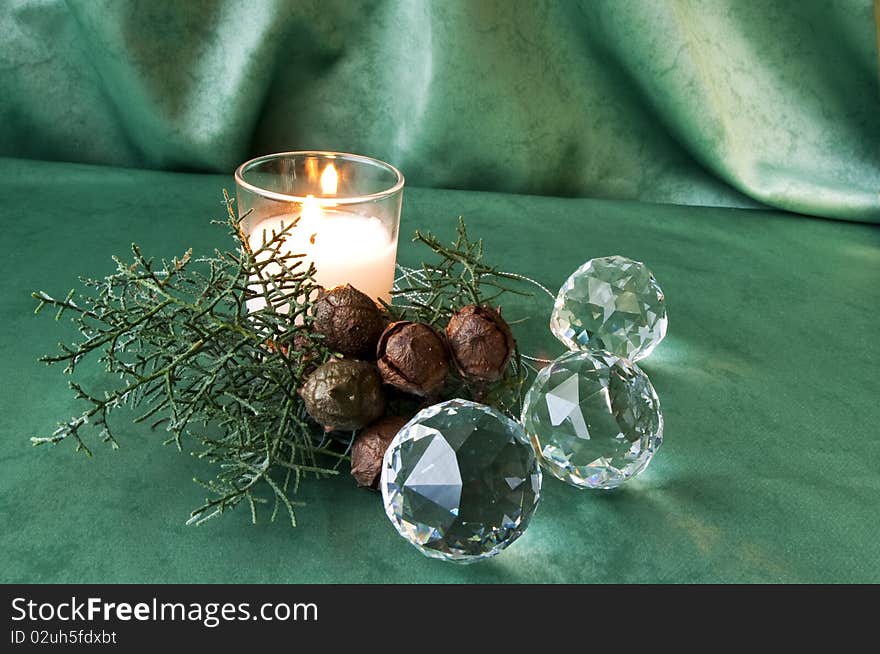 Crystal balls, pine branch and candle on black fabric. Crystal balls, pine branch and candle on black fabric