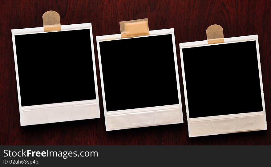 Vintage photo frame polaroid against wood background