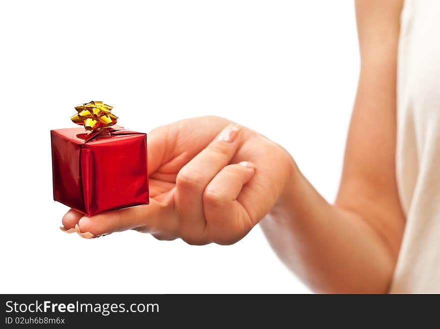 Hand with a small red gift box with gold bow isolated on white background. Hand with a small red gift box with gold bow isolated on white background