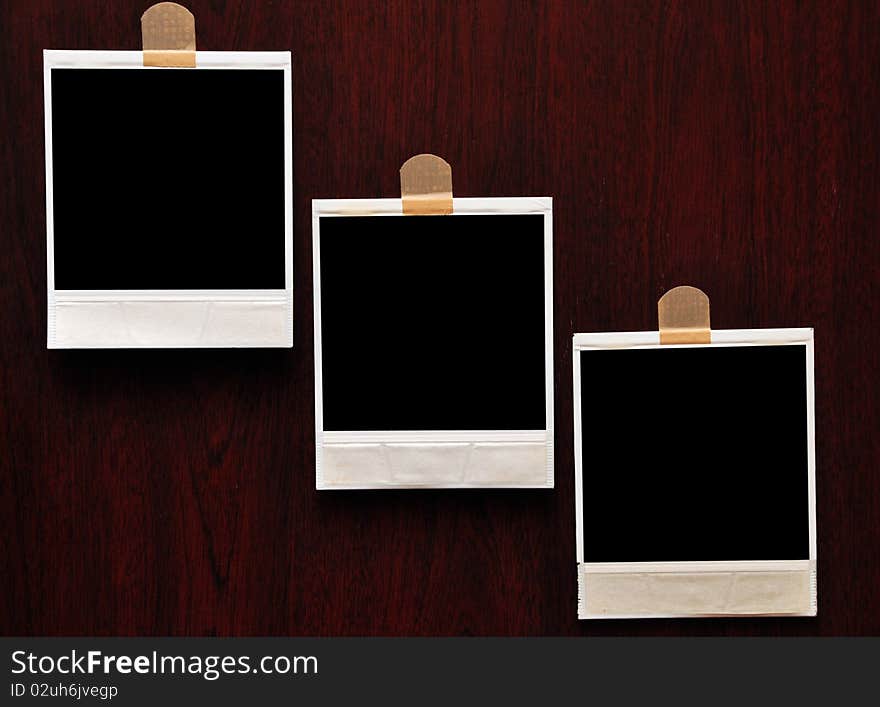 Vintage photo frame polaroid against wood background