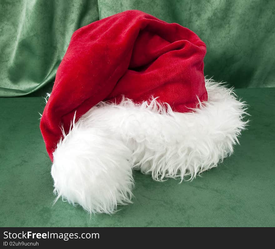 A Santa Claus hat on green background