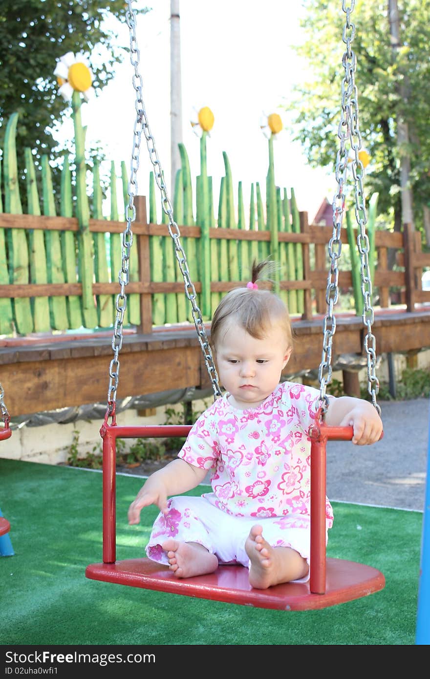 Girl sitting on a swing