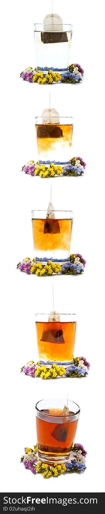 Preparing tea in glass cup with flowers. Isolated on white background