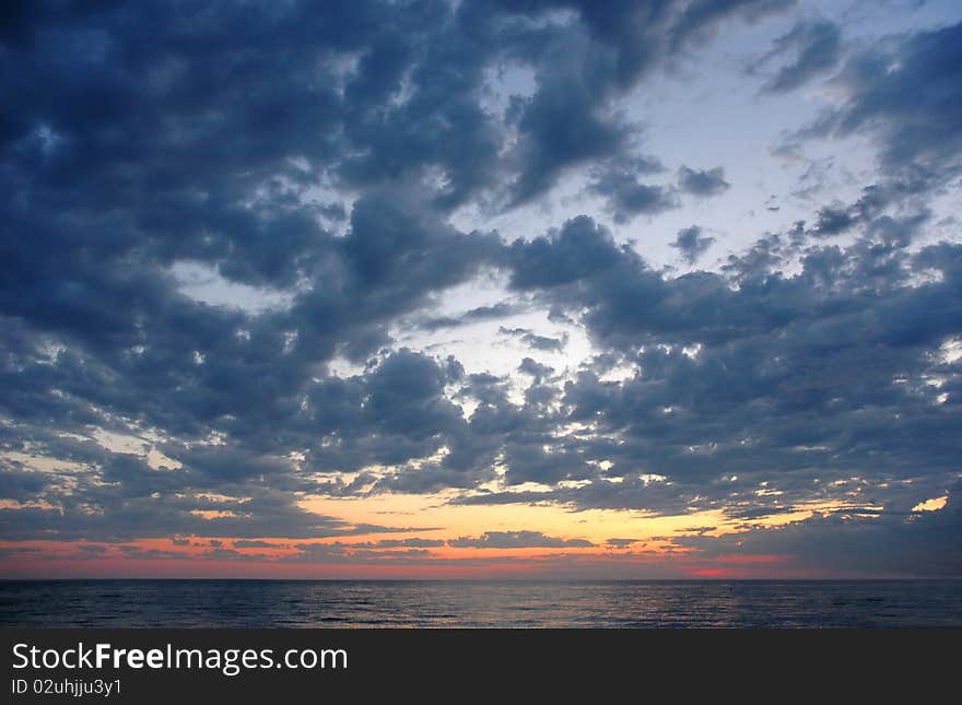 Sundown with clouds on seaside