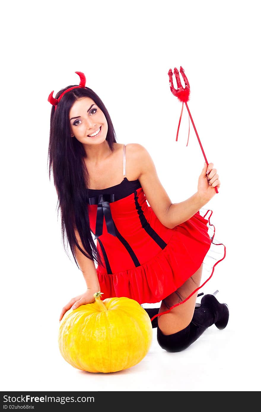 Sexy brunette girl sits, dressed in Halloween costume imp. Sexy brunette girl sits, dressed in Halloween costume imp