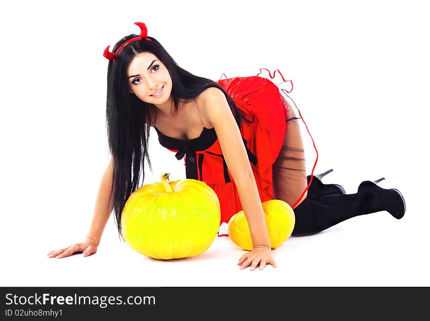 Girl dressed in Halloween costume imp, next