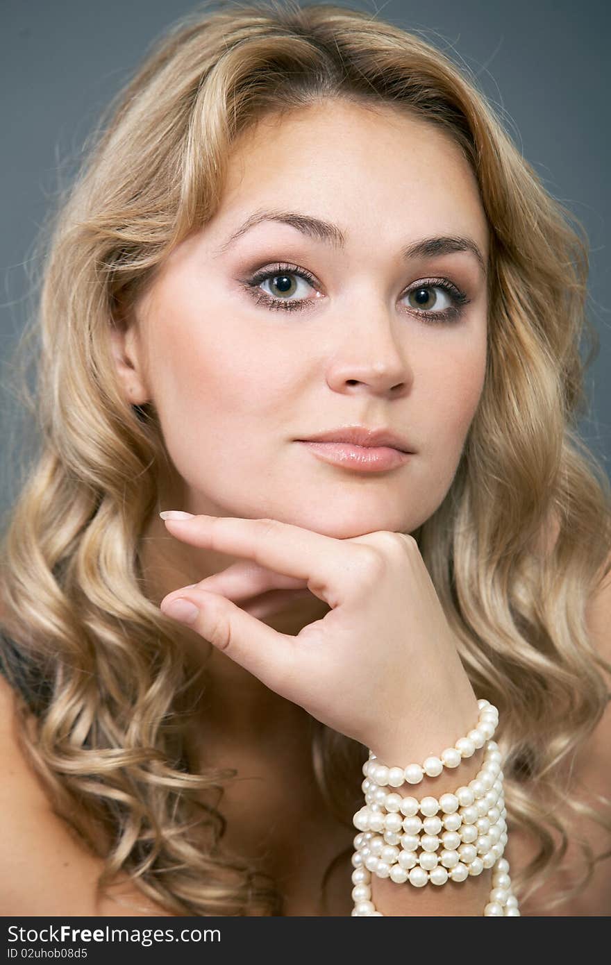 Close up portrait of an attractive blond on a dark background