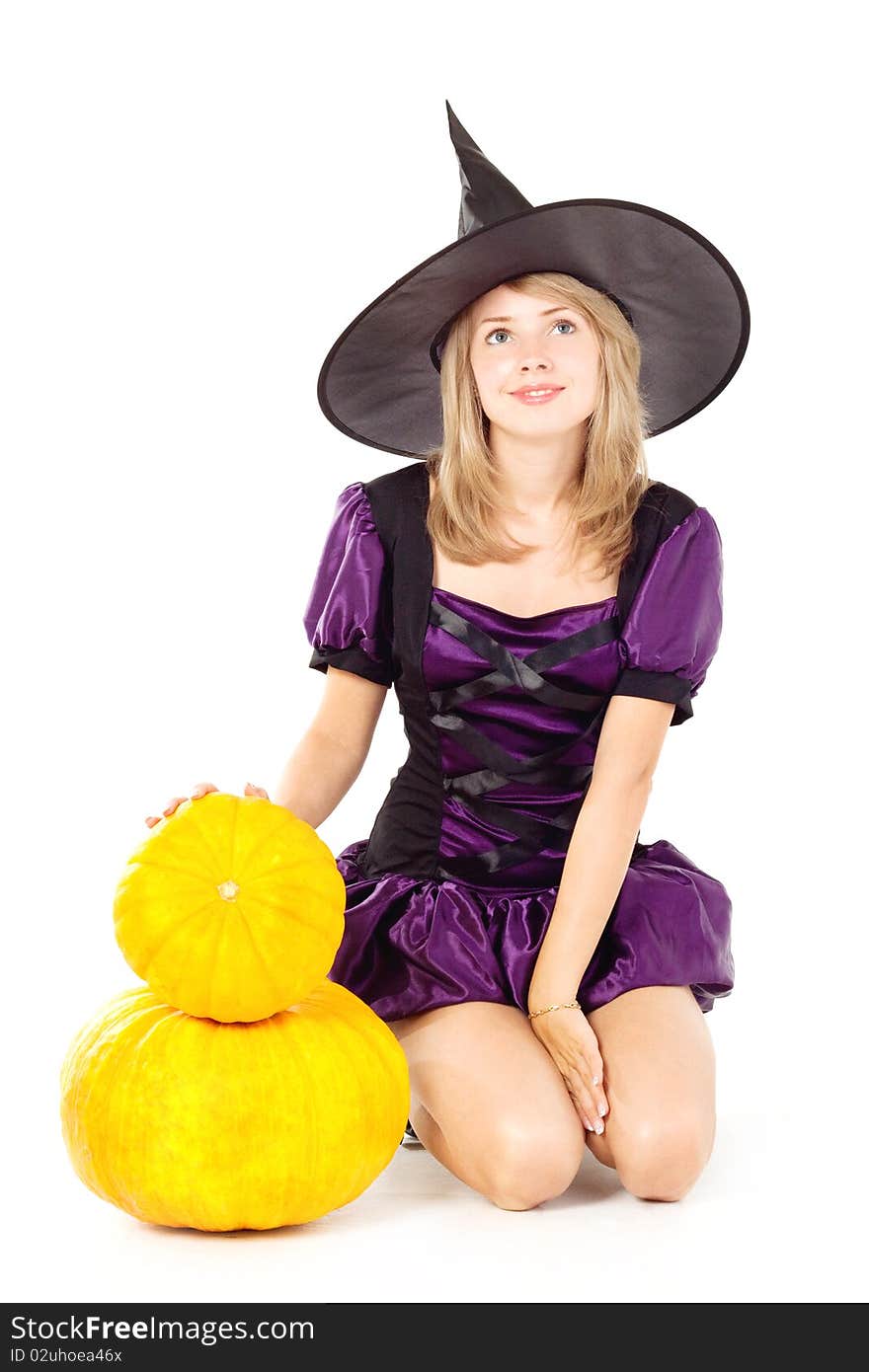 Blonde witch sitting on a pumpkin, holding a pumpkin