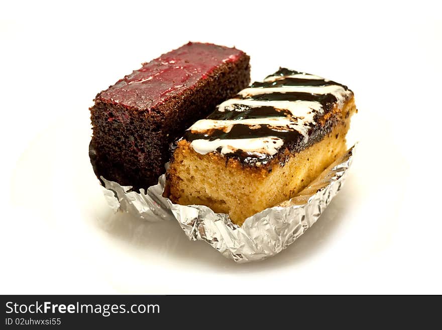 Butter cake topping with cream and chocolate on white background