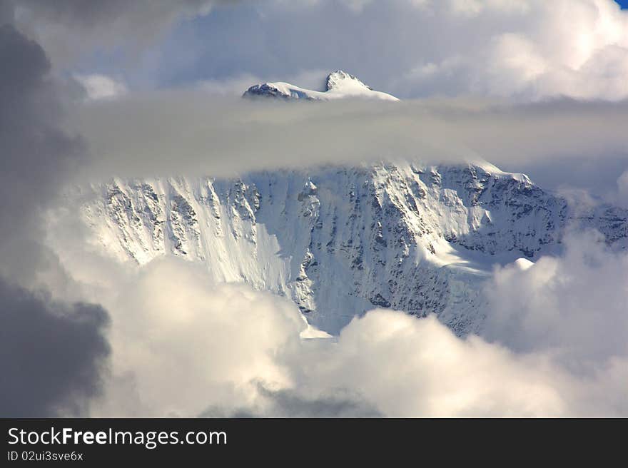 Snowy Mountain Top With Clouds