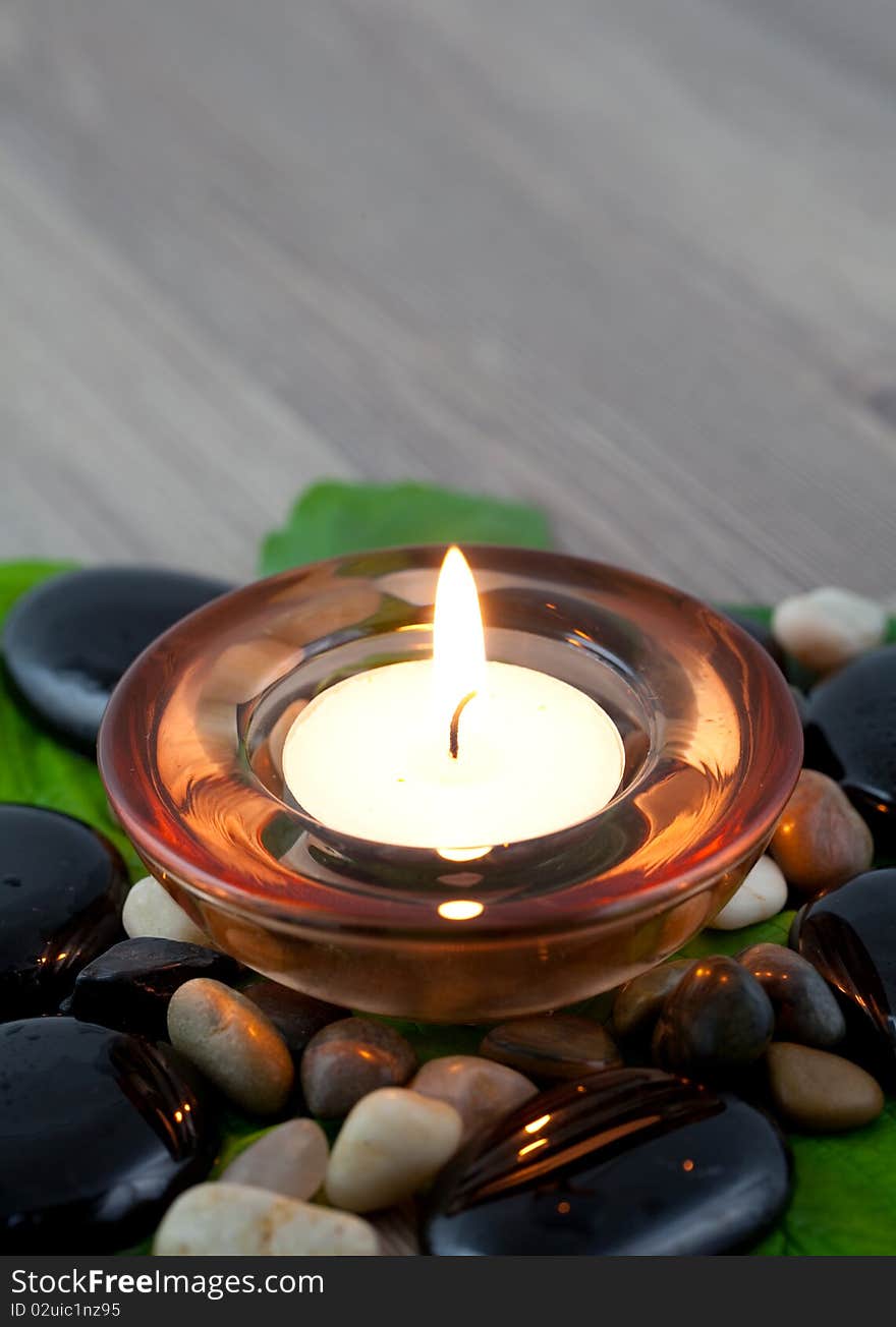 Burning candle with stones and petal. Burning candle with stones and petal