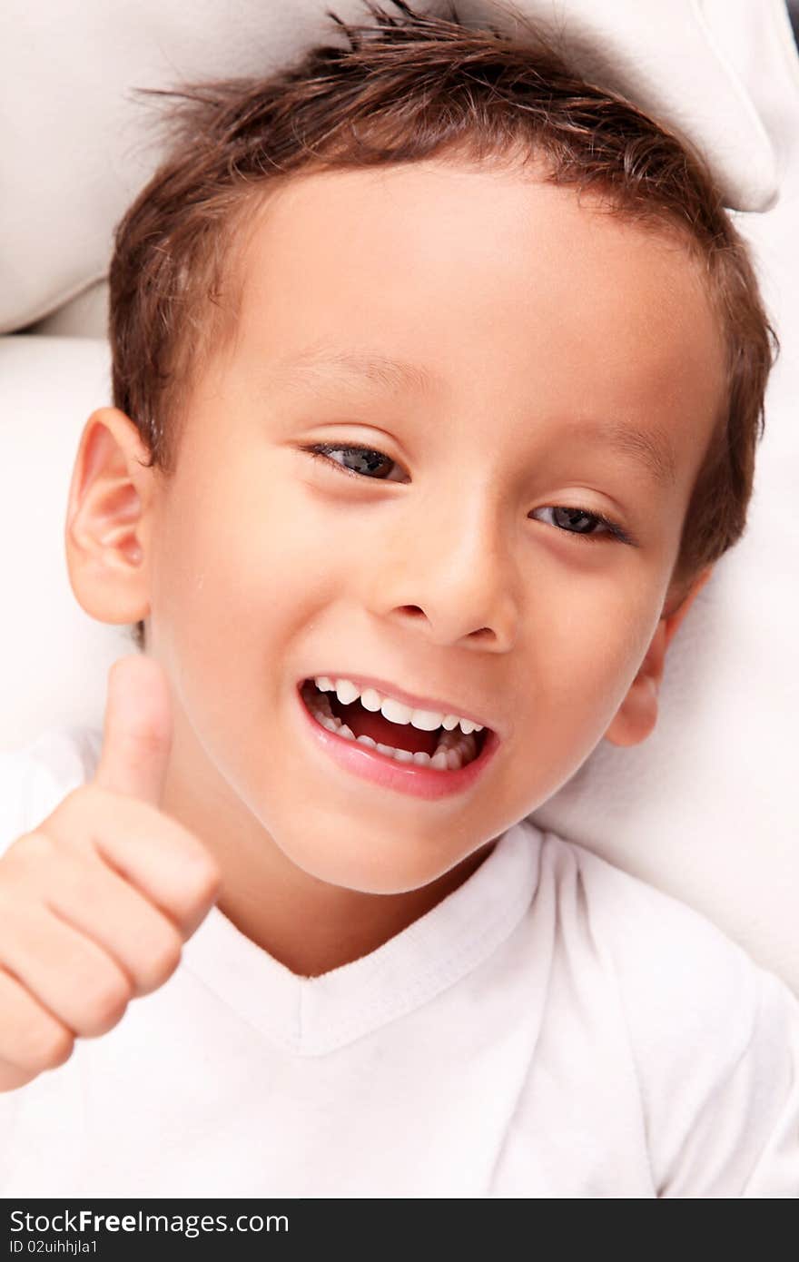 Smiling boy with positive attitude over white background. Smiling boy with positive attitude over white background