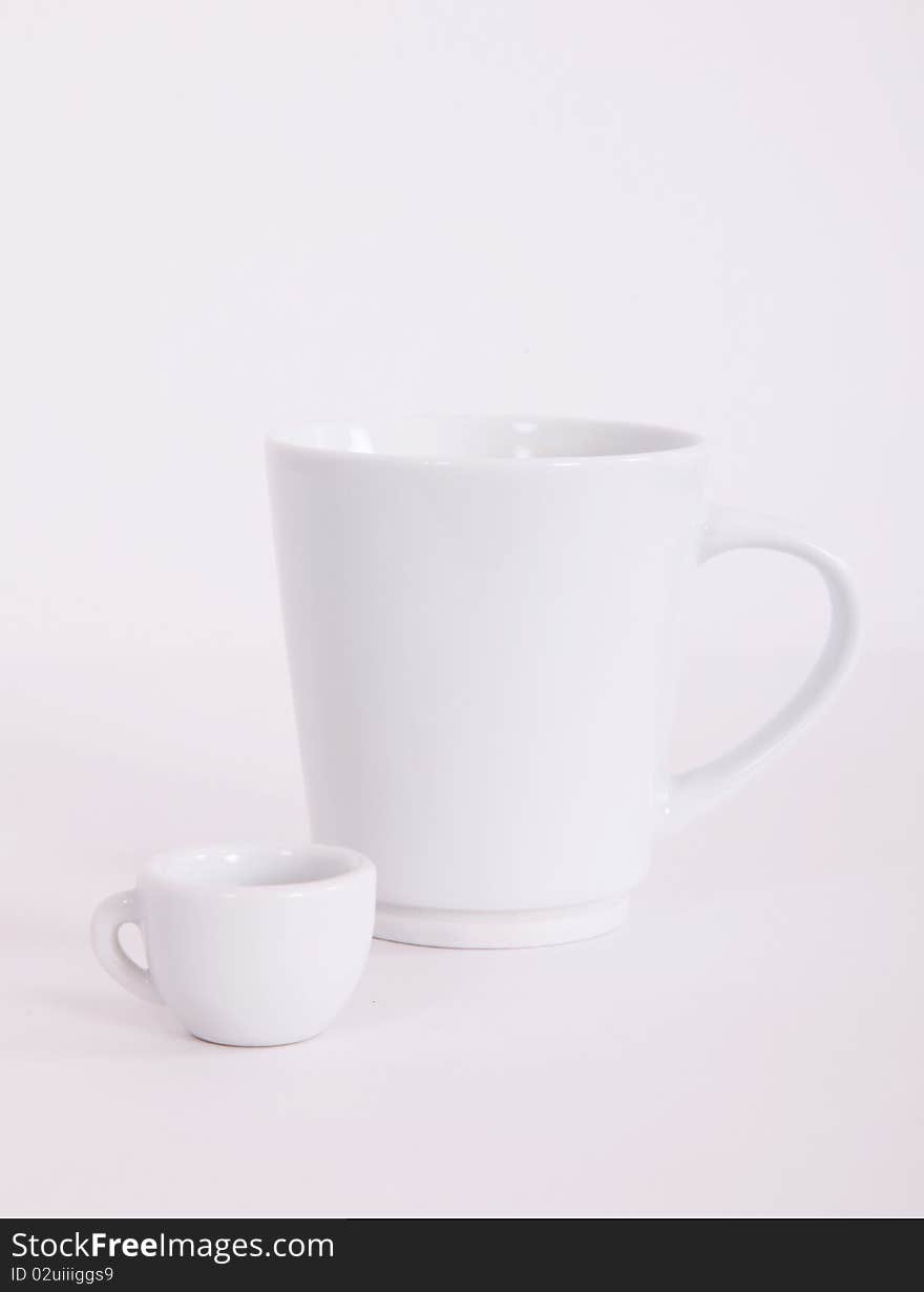 Large white cup and a small. Concept