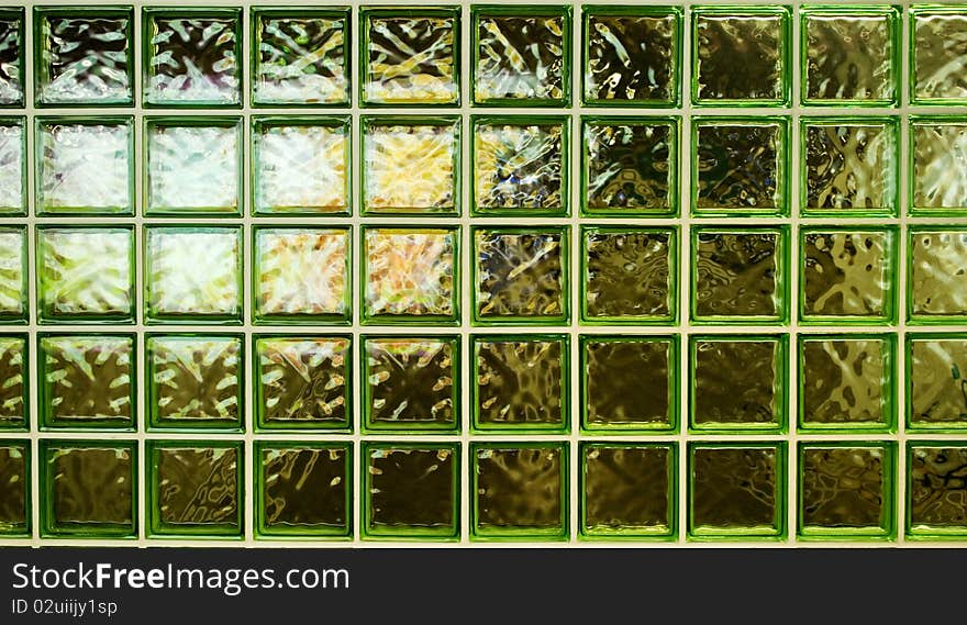 A setion of the green glass wall in the walkways of the citylink tunnel towards esplanade theatre.