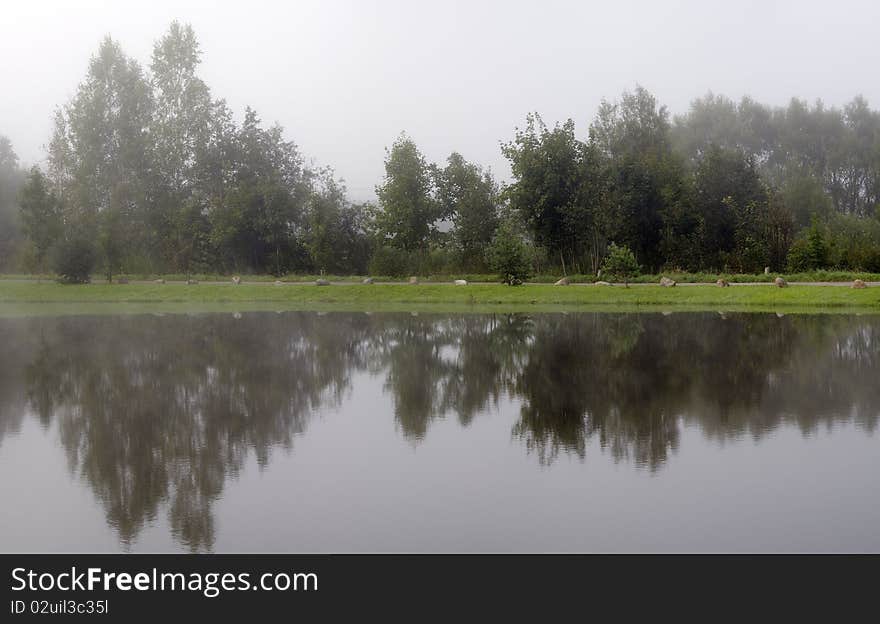 Panorama. Morning fog over a pond