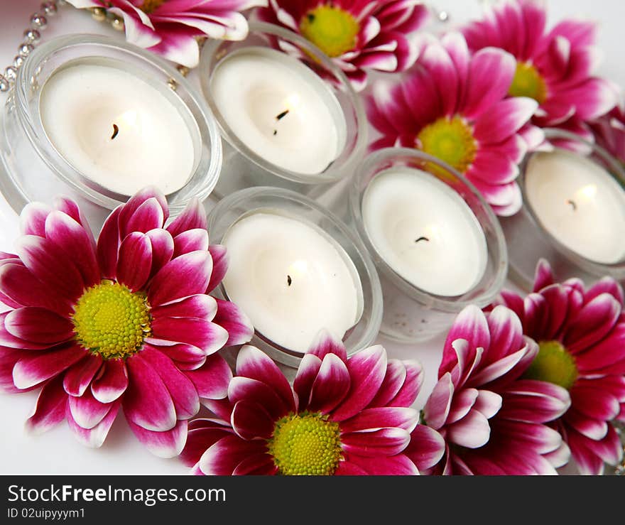 Candles and flowers on a white background