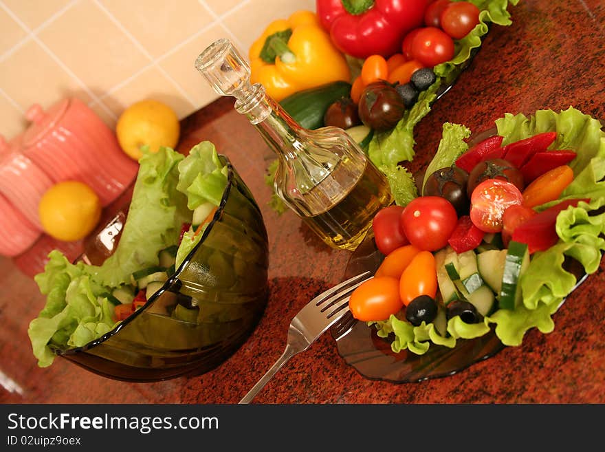 Fresh vegetables and olive oil on a kitchen table. Fresh vegetables and olive oil on a kitchen table