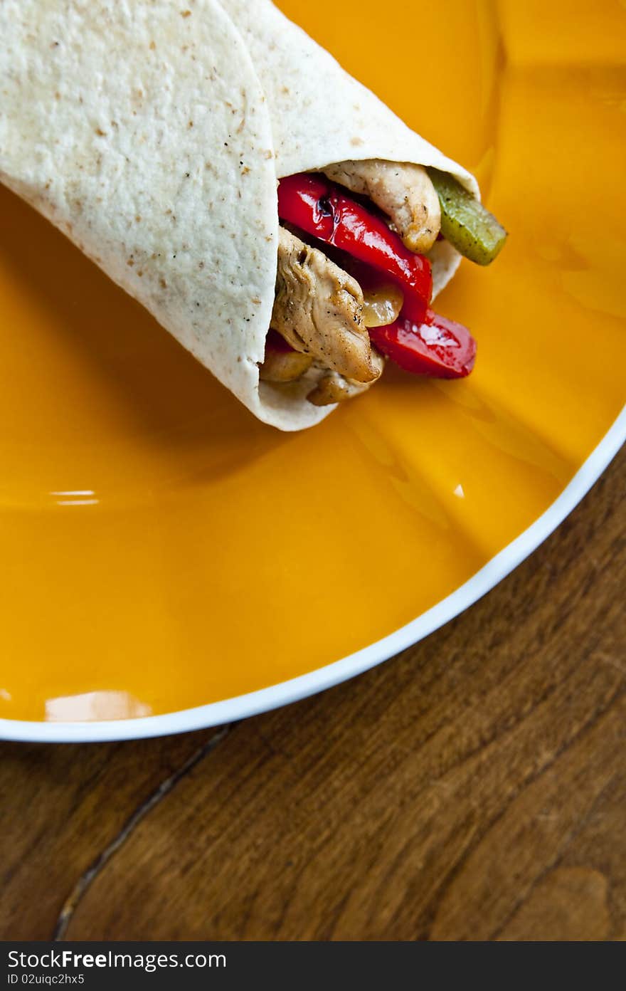 A delicious Mexican chicken fajita with red and green peppers