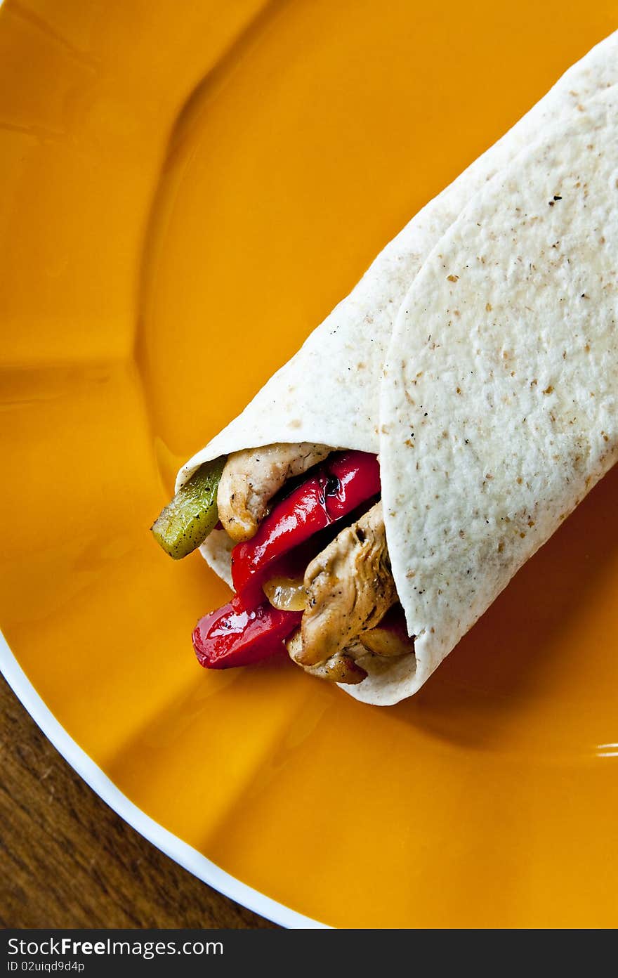 A delicious Mexican chicken fajita with red and green peppers