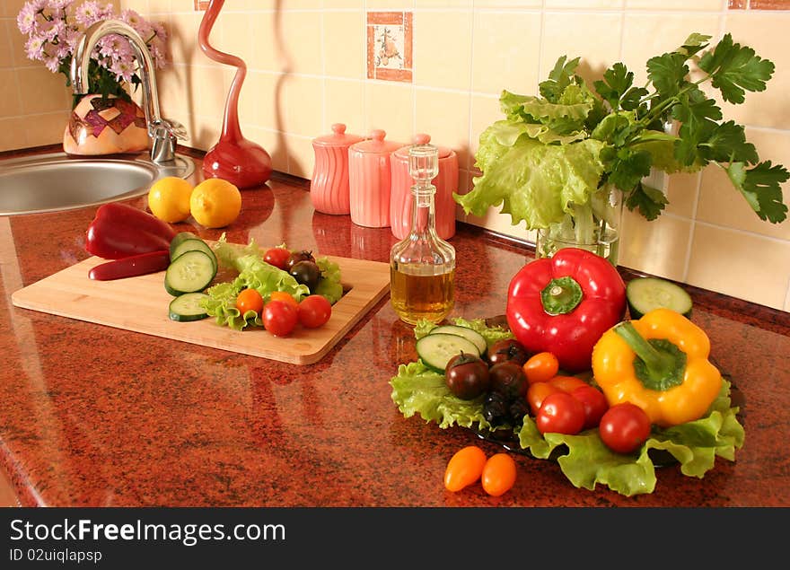 Fresh vegetables and olive oil on a kitchen table. Fresh vegetables and olive oil on a kitchen table