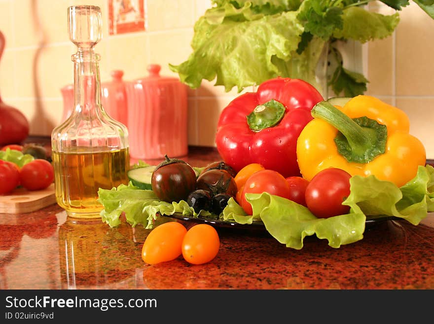 Fresh vegetables and olive oil on a kitchen table. Fresh vegetables and olive oil on a kitchen table