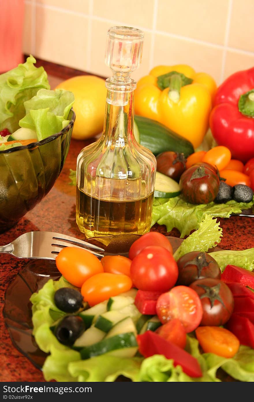 Fresh vegetables and olive oil on a kitchen table. Fresh vegetables and olive oil on a kitchen table