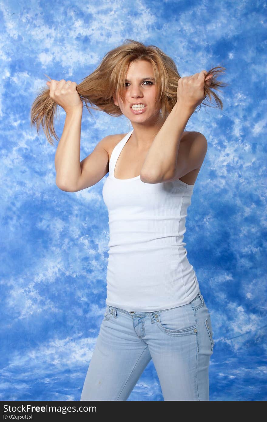 Female model posing anger pushing hair with hands. Female model posing anger pushing hair with hands