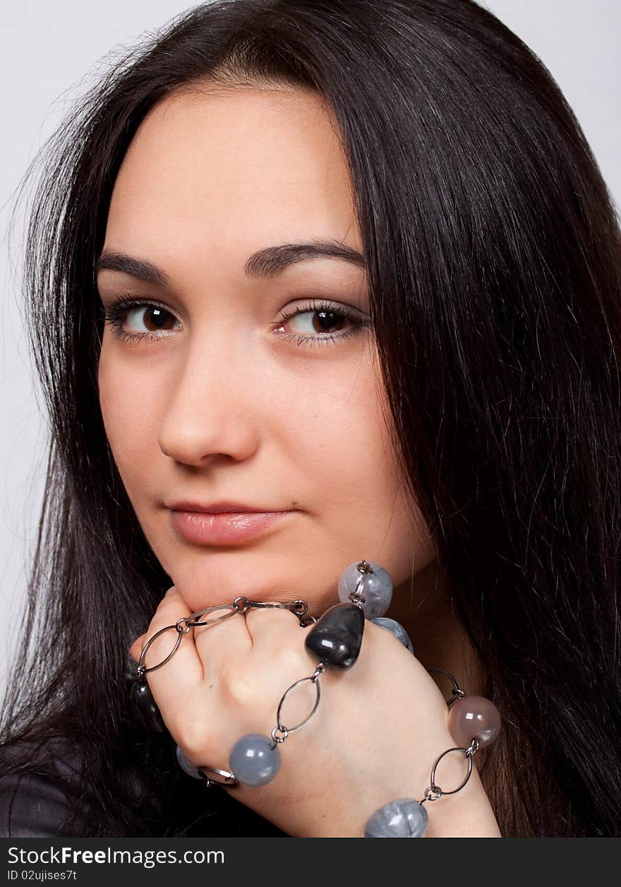 Closeup of attractive brown-eyed girl with glassbeads