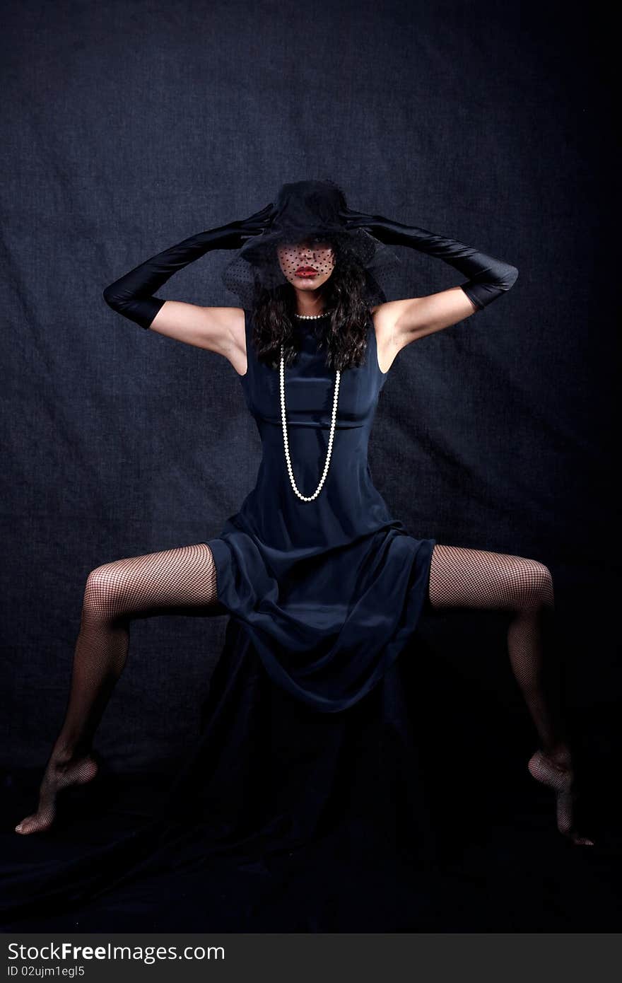 Girl in hat against black background