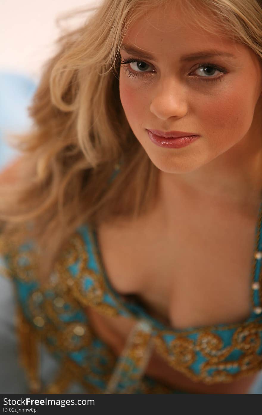 Studio portrait of a belly dancer. Professional make up and hairdo.