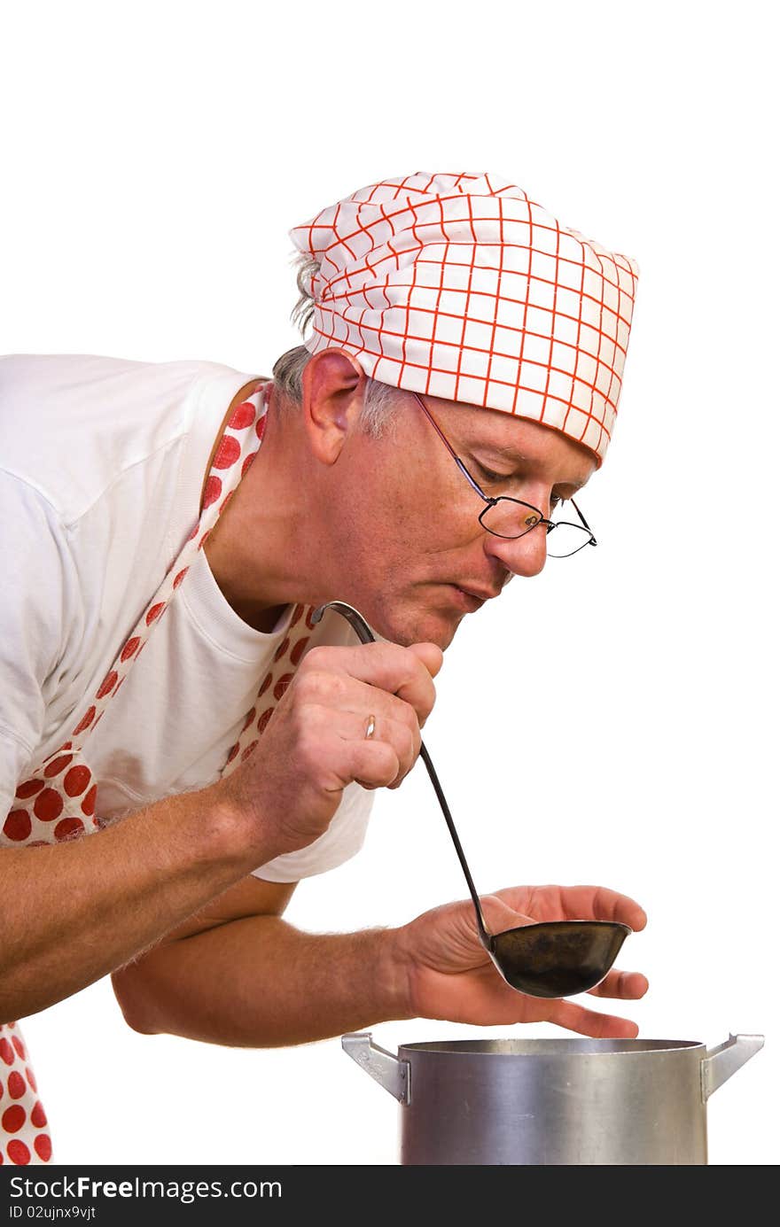 A man with ladle bending to the pot. A man with ladle bending to the pot