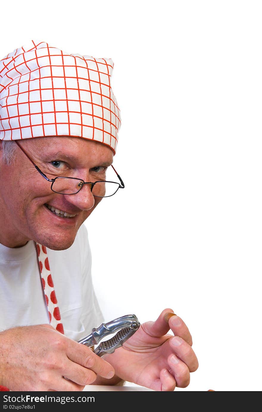 A man with hazelnut and nut cracker in his hands. A man with hazelnut and nut cracker in his hands