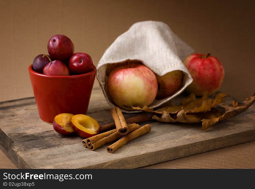 Still-life with apples, plums and cinnamon. Still-life with apples, plums and cinnamon